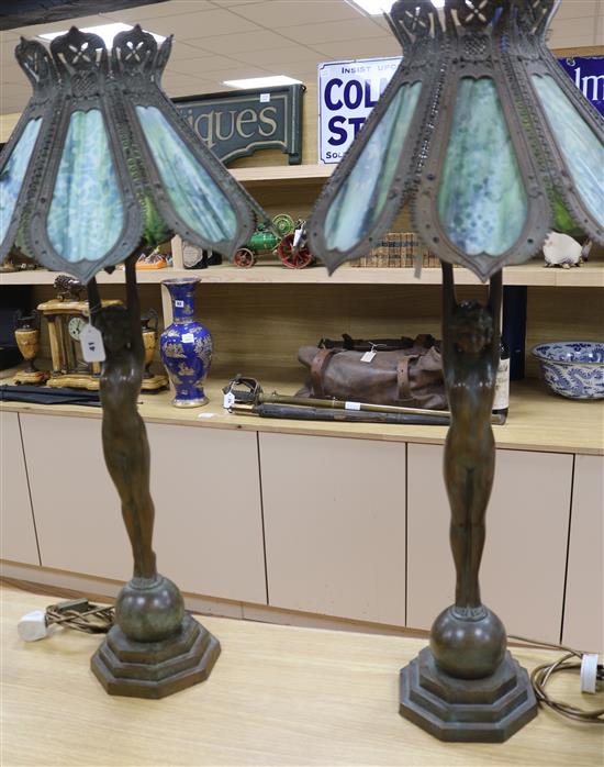 A pair of figural lamps with stained glass shades overall height 96cm